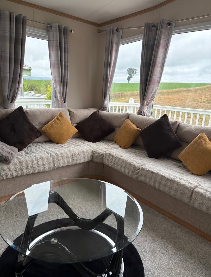 Corner sofa in the living area with countryside views through the windows